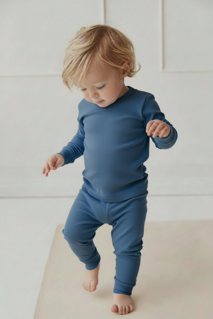 Infant wearing a 2 piece blue fitted pyjama 
